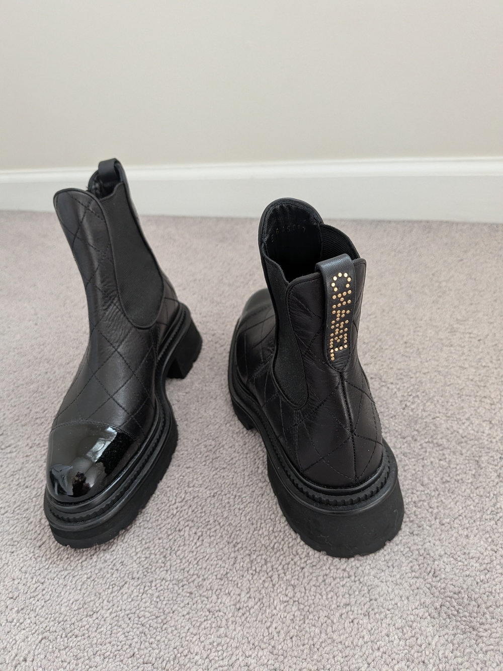 CHANEL Black Quilted Platform Chelsea Booties with Gold Stud Logo
